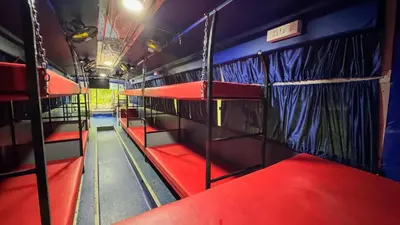 a bus with red and blue bunk beds in it at Great Hornbill Serviced Villa , Nilambur in Kālikāvu