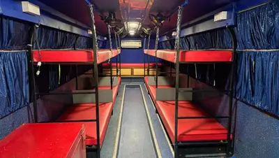 an empty bus with red seats and blue walls at Great Hornbill Serviced Villa , Nilambur in Kālikāvu