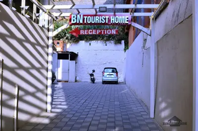 an alley with a car parked next to a building at BN Tourist Home in Ooty