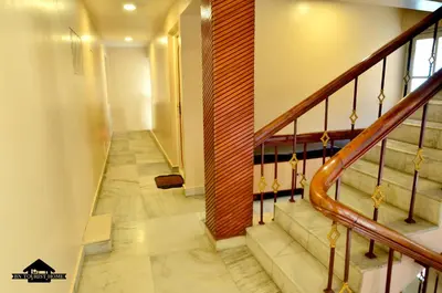 a hallway with stairs in a house at BN Tourist Home in Ooty