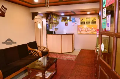 a living room with a couch and a table at BN Tourist Home in Ooty