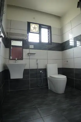a bathroom with a toilet and a sink at Hill Club Square in Malappuram