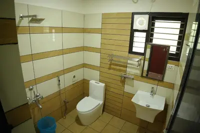 a bathroom with a toilet and a sink at Hill Club Square in Malappuram