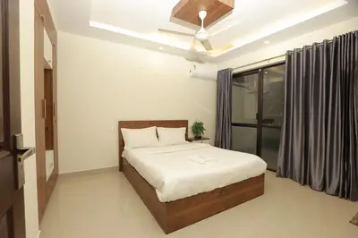 a bedroom with a bed and a ceiling fan at VVP Service Apartments & Airport Suits in Cochin