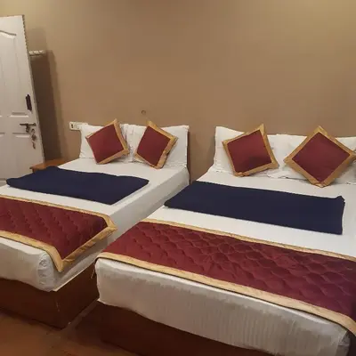 two beds sitting next to each other in a room at RIVERVIEW HOMESTAy in Vālpārai