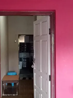 a pink wall with a white door in a room at RIVERVIEW HOMESTAy in Vālpārai