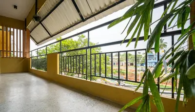 a room with a large window in a building at Trippr Mysuru in Mysore