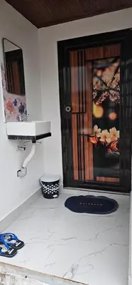 a bathroom with a sink and a door in a room at The Soul Of Vattavada in Vattavada