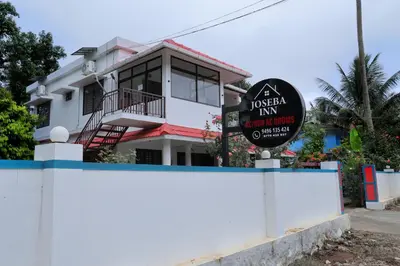 a house with a sign in front of it at Josebaa Inn in Vythiri