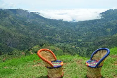two chairs sitting on top of a hill overlooking a valley at Kodaikanal Luxuries Glamp - Krishna Paradize in Kūkkāl