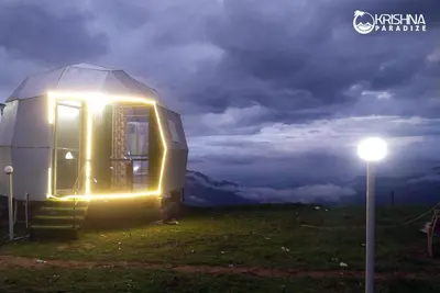 a small dome house with a light on a field at Kodaikanal Luxuries Glamp - Krishna Paradize in Kūkkāl