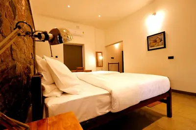 a bedroom with a white bed in a room at The Hidden Pearl Palakkad by Chakolas Hospitality in Thenkurissi