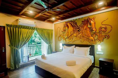 a bedroom with a bed with a horse on the wall at Falcon Riverview Resorts in Kuttampuzha