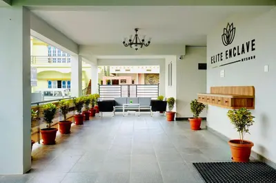 a lobby with a table and chairs and potted plants at Elite Enclave - Mysore - 2BHK Luxury Serviced Apartments in Mysore