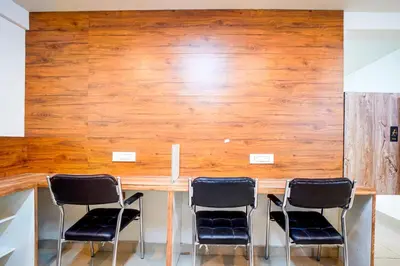 a conference room with a table and four chairs at Elite Enclave - Mysore - 2BHK Luxury Serviced Apartments in Mysore