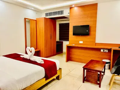 a bedroom with a bed with a white bunny on it at Hotel Starfinch Inn in Kushālnagar