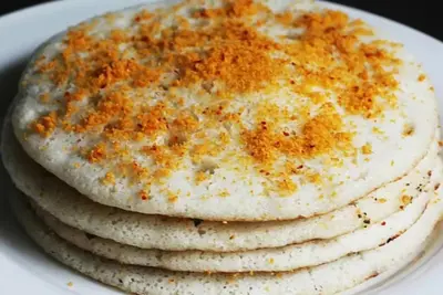 a stack of pancakes on a white plate at Hotel president park Coimbatore in Coimbatore