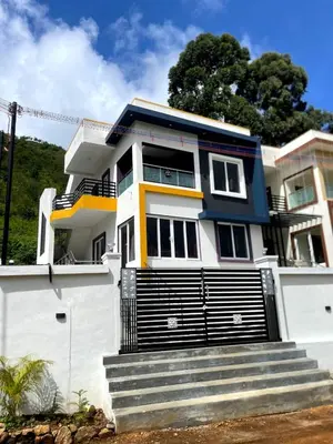 a house with stairs in front of it at Siesta Inn- Mountain View in Kodaikānāl