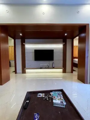 a living room with a flat screen tv on a wall at Siesta Inn- Mountain View in Kodaikānāl