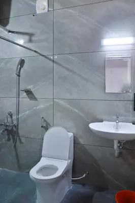 a bathroom with a toilet and a sink at Palatty Residency in Angamali
