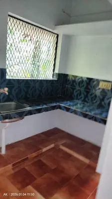 a room with a window and a tile floor at Palatty Residency in Angamali