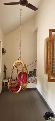a hanging swing in a room with a ceiling at Agraharam Hindu Home stay - Advaitham in Palakkad