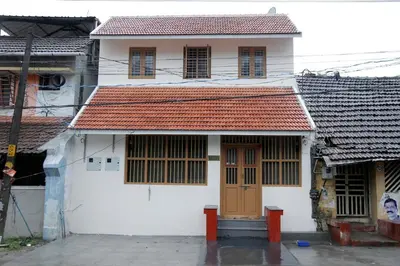 a white house with a red roof at Agraharam Hindu Home stay - Advaitham in Palakkad