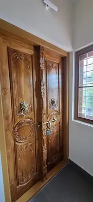 a wooden door in a room with a window at Agraharam Hindu Home stay - Advaitham in Palakkad
