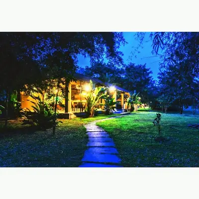 a pathway in front of a house at night at The Road's End in Gonikoppal