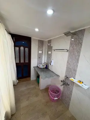 a bathroom with a sink and a faucet at Rozana Retreats Ooty in Ooty