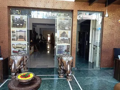 a store front with two chairs and a cake on a table at SAK Royal Residency 1 km from Railway Station in Mysore