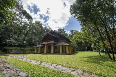 a small house in a park with a grass yard at Pepper Trail in Sultan Bathery