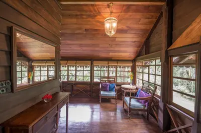 a large room with wooden walls and windows at Pepper Trail in Sultan Bathery
