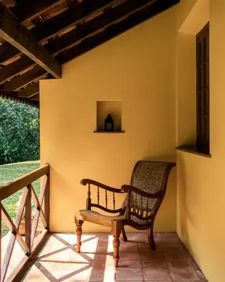 a chair on the porch of a house at Pepper Trail in Sultan Bathery
