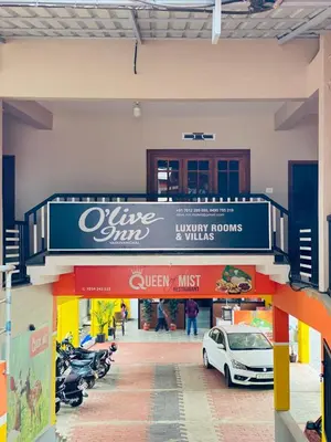 a sign for a wine shop with a car parked at O'live Inn Wayanad Apart-Hotels in Vaduvanchal