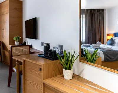 a hotel room with a desk and a mirror at ESPERO INN Malappuram in Malappuram