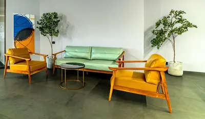 a couch and two chairs in a room at ESPERO INN Malappuram in Malappuram