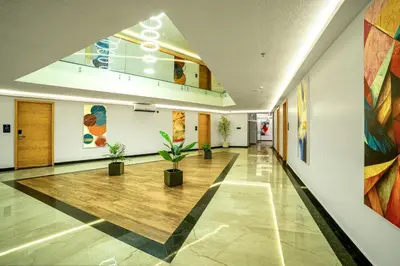 an empty hallway with plants in a building at ESPERO INN Malappuram in Malappuram