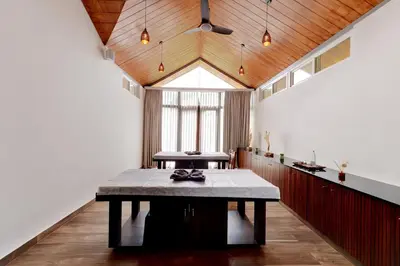 a dining room with a table and a window at Sandesh Water Edge Kabini in Begūr