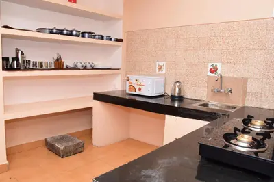 a kitchen with a counter top and a microwave at Rosewood 1 in Ooty