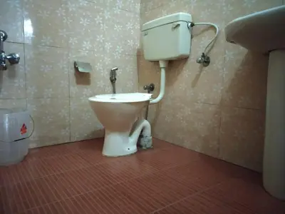 a bathroom with a toilet in a bathroom stall at Rheinberg Town Haus in Munnar
