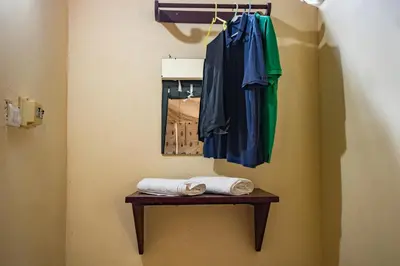 a robe and towels on a table next to a mirror at Amritara Riverside Camp in Thattakād