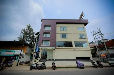 a group of motorcycles parked in front of a building at Mount Land in Sultan Bathery