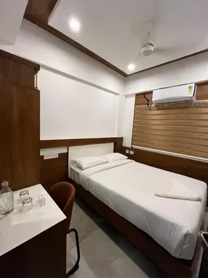 a hotel room with two beds and a sink at Welcome Hotels in Trichūr