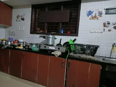 a kitchen with a sink and a counter top at Coorg Sunway home stay in Madikeri