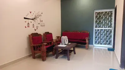 a room with chairs and a table and a window at Coorg Sunway home stay in Madikeri