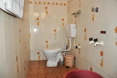 a small bathroom with a toilet in a room at County Pep in Wayanad