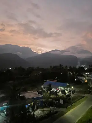 a view of a city with mountains in the background at Bro Code Marayoor A Premium Family Friendly Retreat with Panoramic Mountain Views in Marayoor