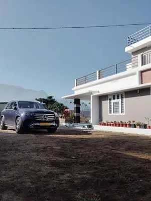 a car parked in front of a house at Bro Code Marayoor A Premium Family Friendly Retreat with Panoramic Mountain Views in Marayoor
