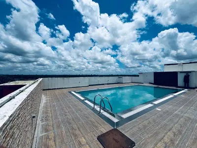 a swimming pool on the roof of a building at Transit suites by Habitat in Cochin
